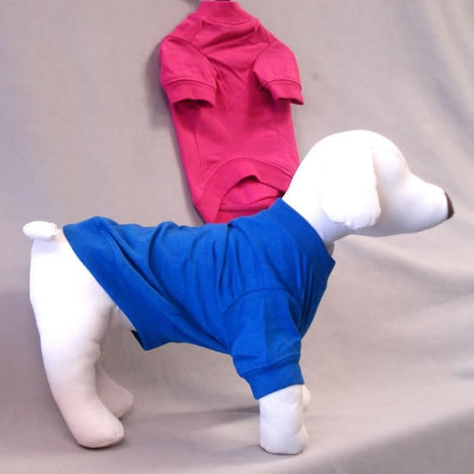 A white dog mannequin modeling the Nautical Blue Basic Dog Tee Shirt, with the Raspberry Sorbet color in the background.