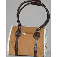 One side of the Berber Dog Carrier showing the camel color and brown straps.