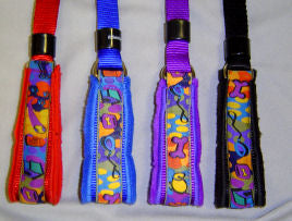 Detail of the four colors of the EZ Collar; Red, Blue, Purple, and Black.
