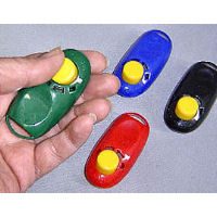 The i-Click clicker shown being held in a hand.