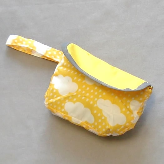 The Reversible Raincoat folded into its pouch.
