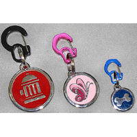 Three dog I.D. tags attached to the Rubit I.D. Tag holder in three different sizes. The Large Rubit is black, the Medium is Pink, and the small is Blue.