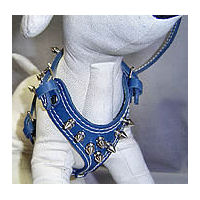 A white dog mannequin wearing the blue Spiked Leather Harness.