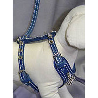 Side view of the blue Spiked Leather Harness on a white dog mannequin.