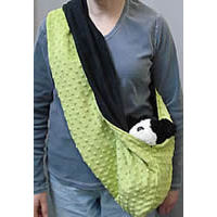 The Reversible Sling Carrier shown on a person with a stuffed dog in the sling.