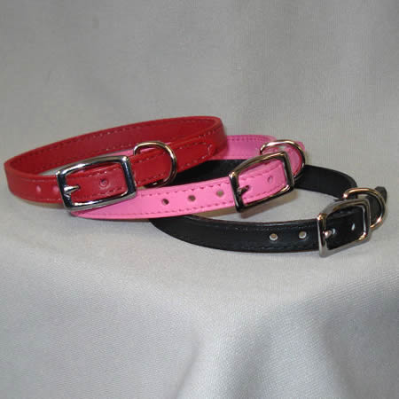 Three small buckle dog collars red, pink, and black with silver-color findings.