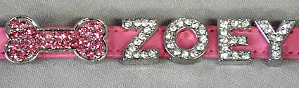 Close-up of the pink charm with pink bone and name "ZOEY" in crystal charms.