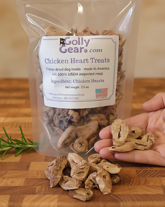 The 2.5 ounce pouch of Chicken Heart Treats with a hand showing the size of the pieces.